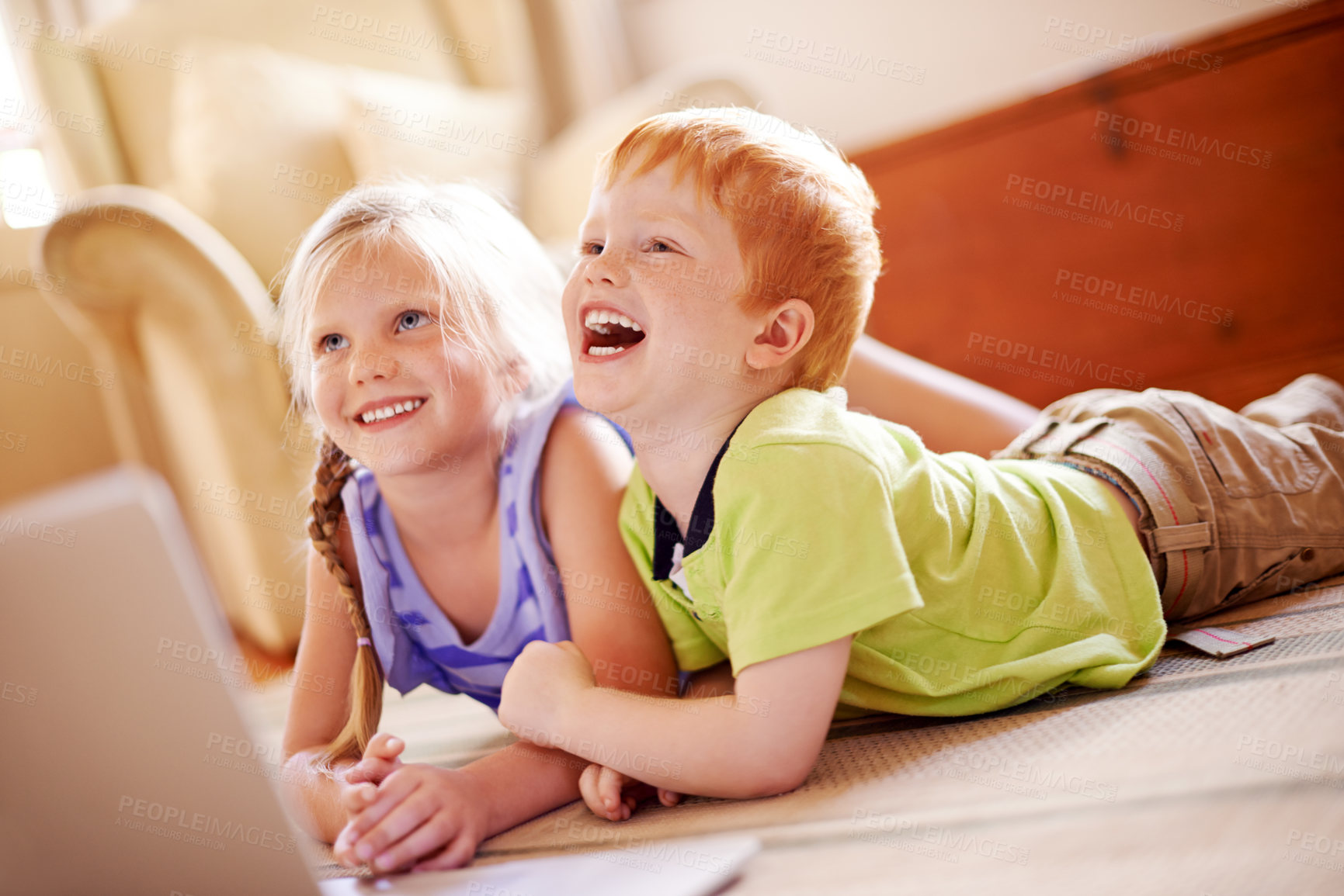 Buy stock photo Children, relax and laugh on floor at house for funny joke, playful morning and bonding together. Smile, kids and rest on laptop for streaming movies, educational videos and affection of relationship