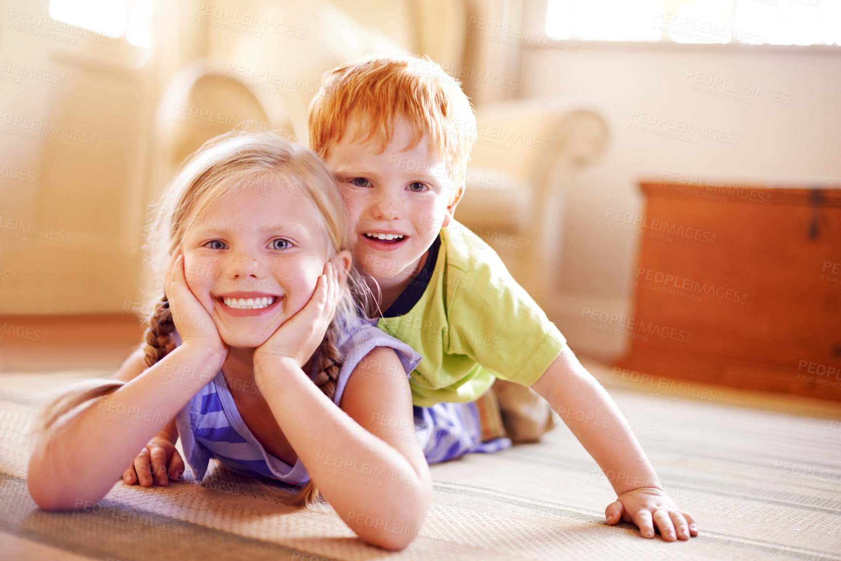 Buy stock photo Portrait, playful girl and boy with siblings in home for bonding, love and happiness in childhood. Fun, games and family on living room floor for playing children with brother and sister hug in house