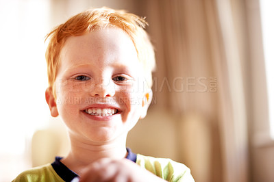 Buy stock photo Boy, portrait and smile with kid in home for child development, growth or playful expression. Adorable, cute or growing up and happy youth with red hair in apartment for innocence or childhood