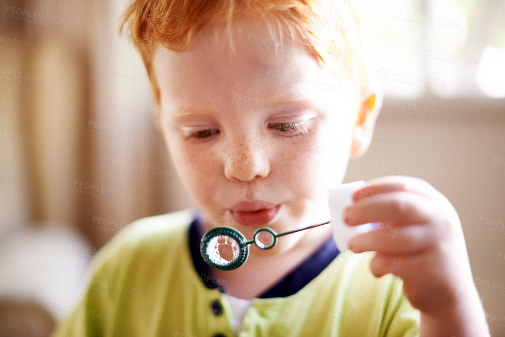 Buy stock photo House, blowing bubbles and boy with fun, game and playful with activity, learning and break. Soap, apartment and kid with growth, motor skills and youth development with child and wand in living room