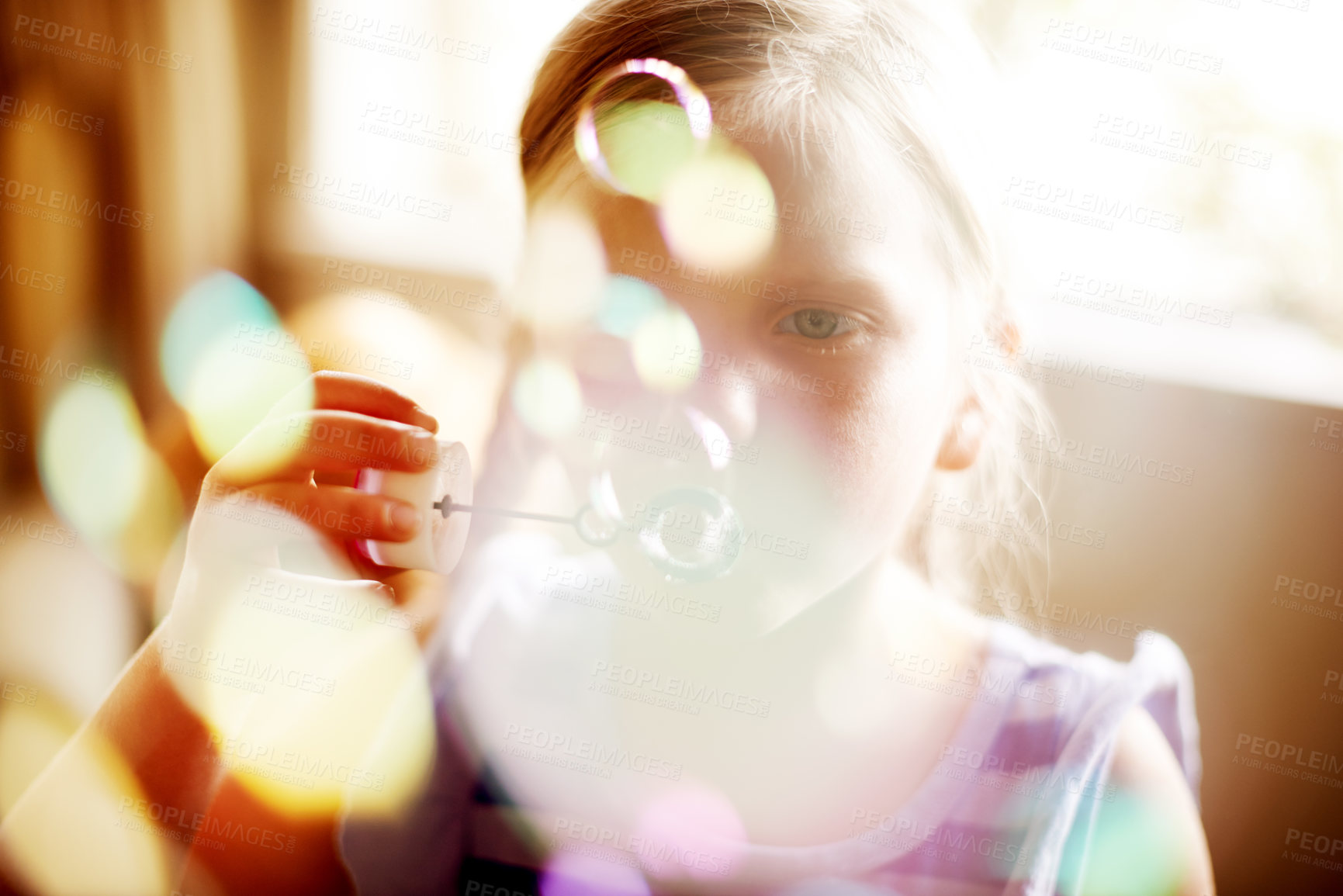 Buy stock photo Girl, child or blowing bubbles with bokeh for sensory stimulation, cognitive development or creative activity. Home, person or wand with liquid soap for playing fun game, coordination or motor skills