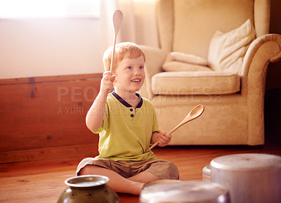 Buy stock photo Drums, music and pots with boy on living room floor of home to imagine fantasy band or concert. Instrument, pans or playing and happy child with wooden spoons for beating or rhythm in apartment