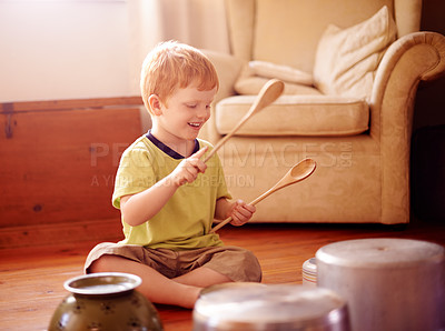 Buy stock photo Home, drum and boy with pots, pans and playful with noise, energy and activity. Happy child, apartment and kid in living room, wooden spoons and cheerful with music, funny or hyperactive with game