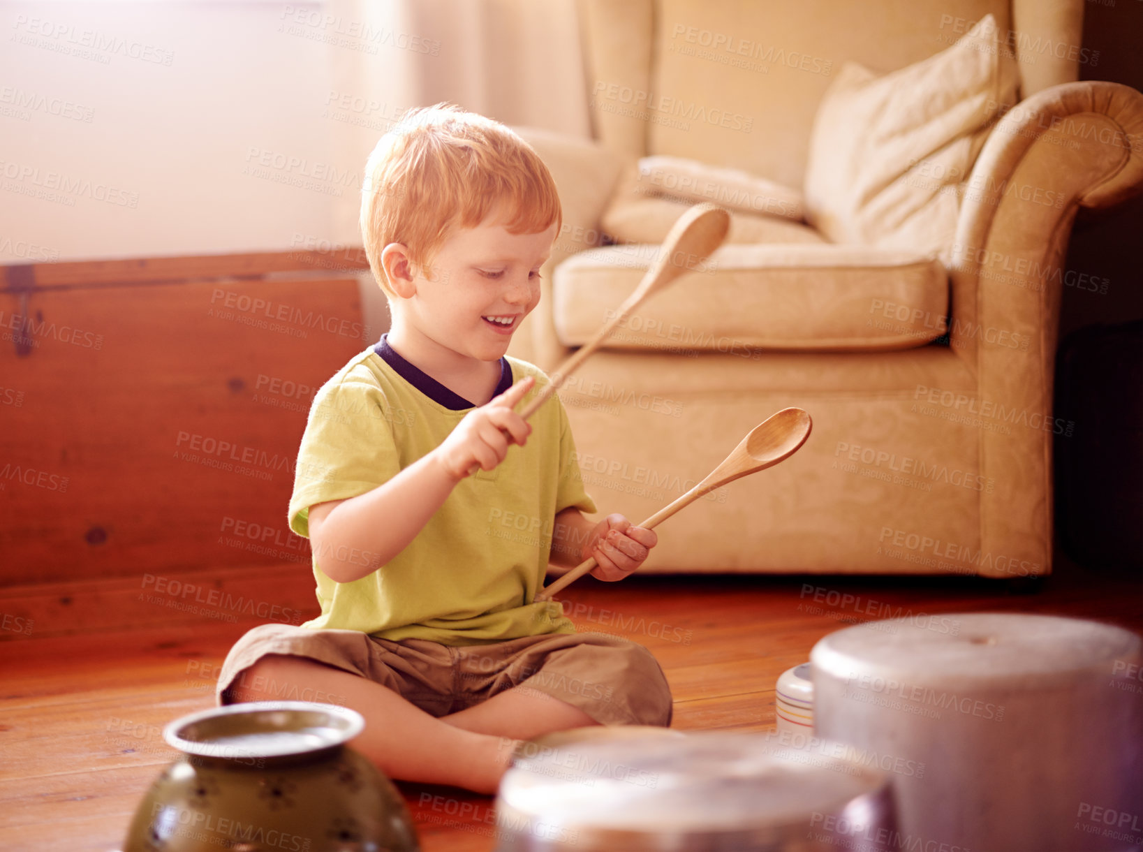 Buy stock photo Home, drum and boy with pots, pans and playful with noise, energy and activity. Happy child, apartment and kid in living room, wooden spoons and cheerful with music, funny or hyperactive with game