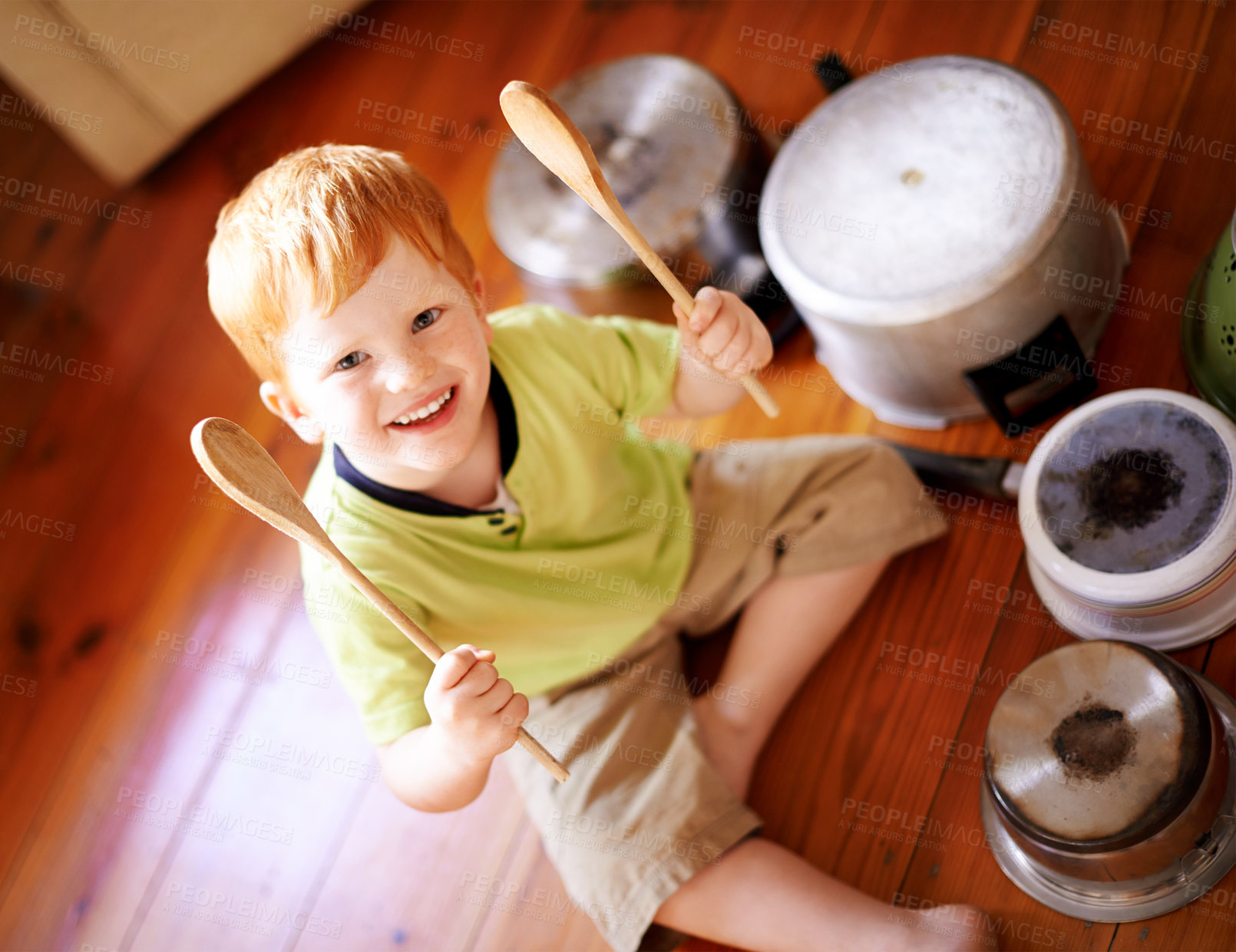 Buy stock photo Drummer, portrait and pots with smile of boy on wooden floor in home living room from above. Cookware, crockery and instrument with happy child in apartment for fantasy, imagination or playing music