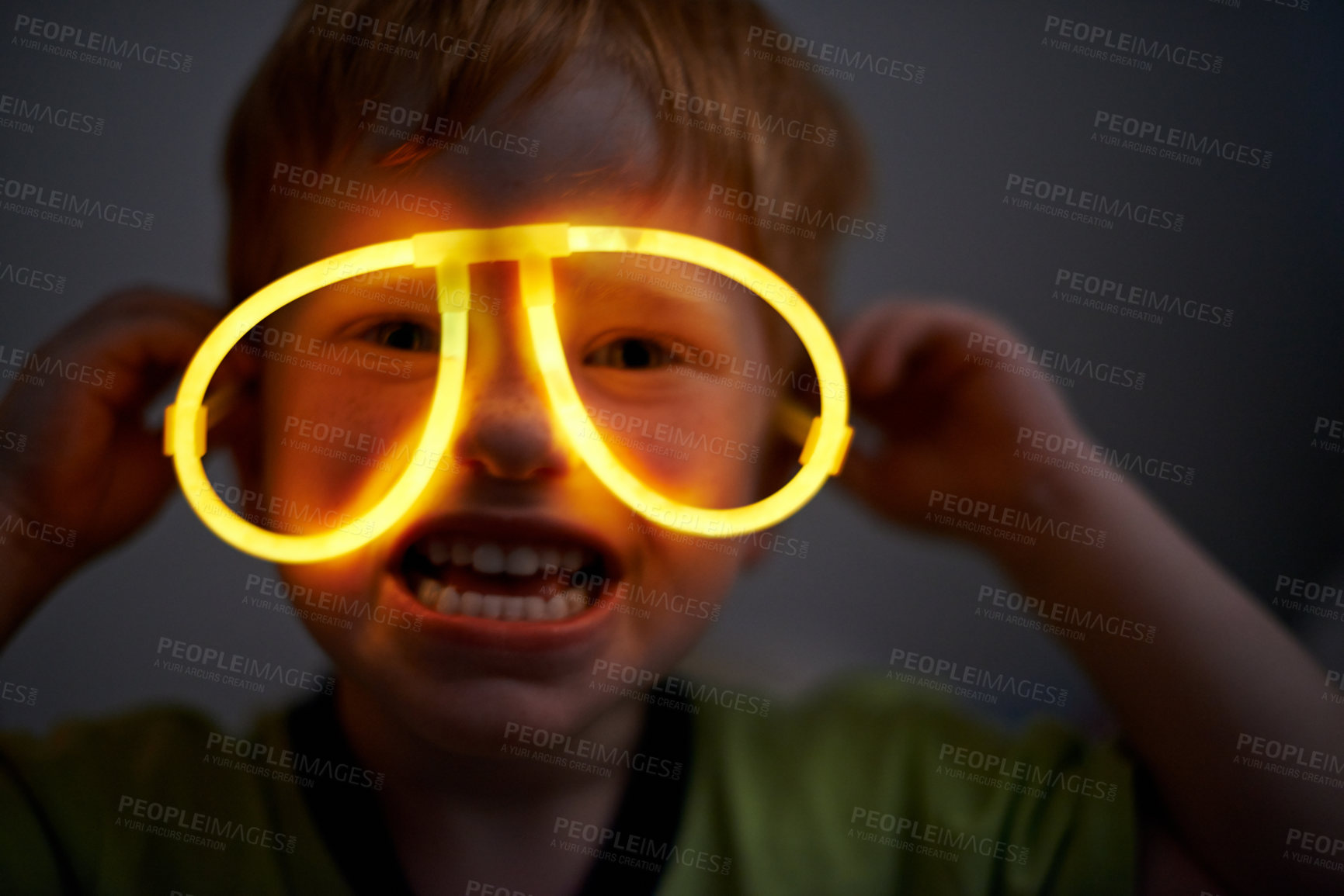 Buy stock photo Night, child and neon glasses in portrait for fun, playing and crazy face for Halloween party in home. Kid, young boy and fluorescent eyewear in dark for cyberpunk birthday theme in silly childhood