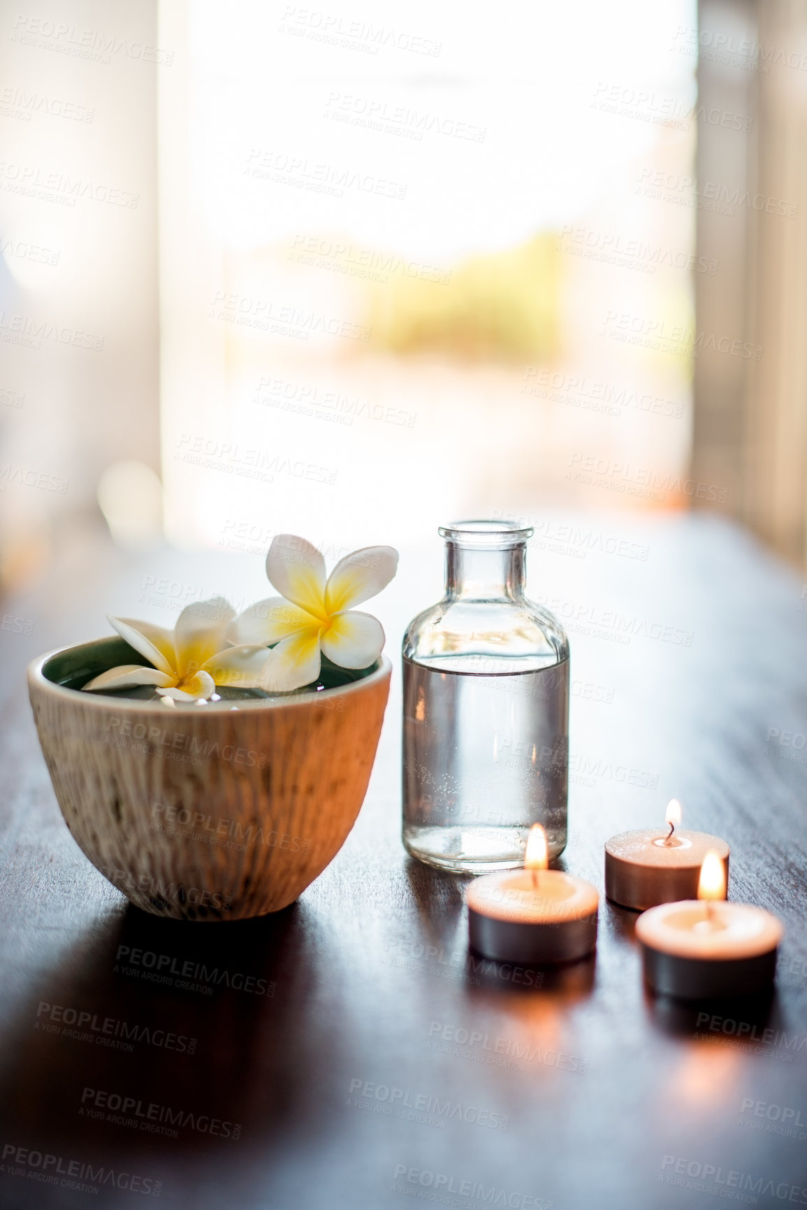 Buy stock photo Spa, wellness and essential oil with flower in bowl for aromatherapy, pamper retreat and luxury treatment. Tranquil space, body care salon and empty room for stress relief, relaxation and hospitality