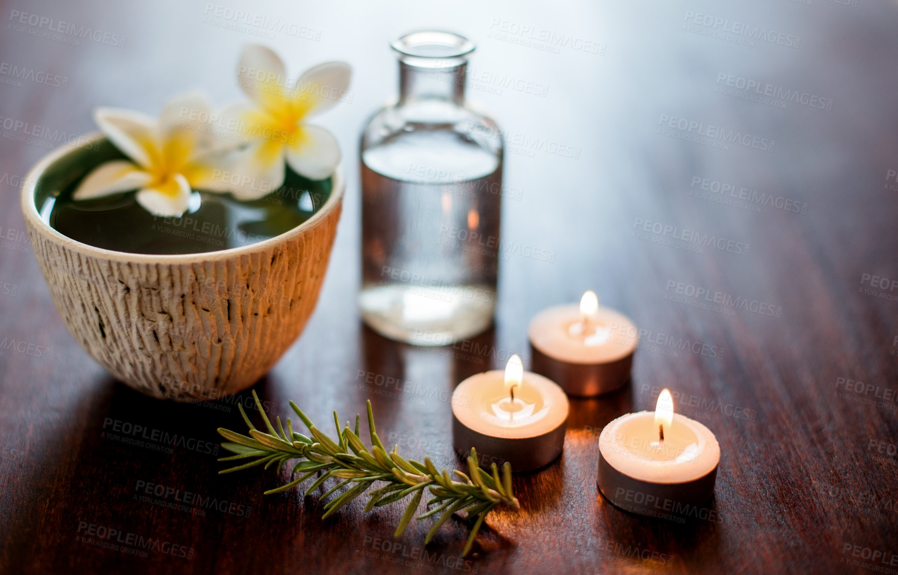 Buy stock photo Flowers, candles and bowl of water in spa for self care, wellness and beauty treatment. Salon aesthetic, holistic and rosemary herbs for cosmetics, aromatherapy and health for zen, calm and peace