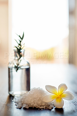 Buy stock photo Spa, wellness flower and essential oil with salt on table for aromatherapy arrangement and luxury treatment. Space, health salon and empty room with minimalist setup, natural products and self care