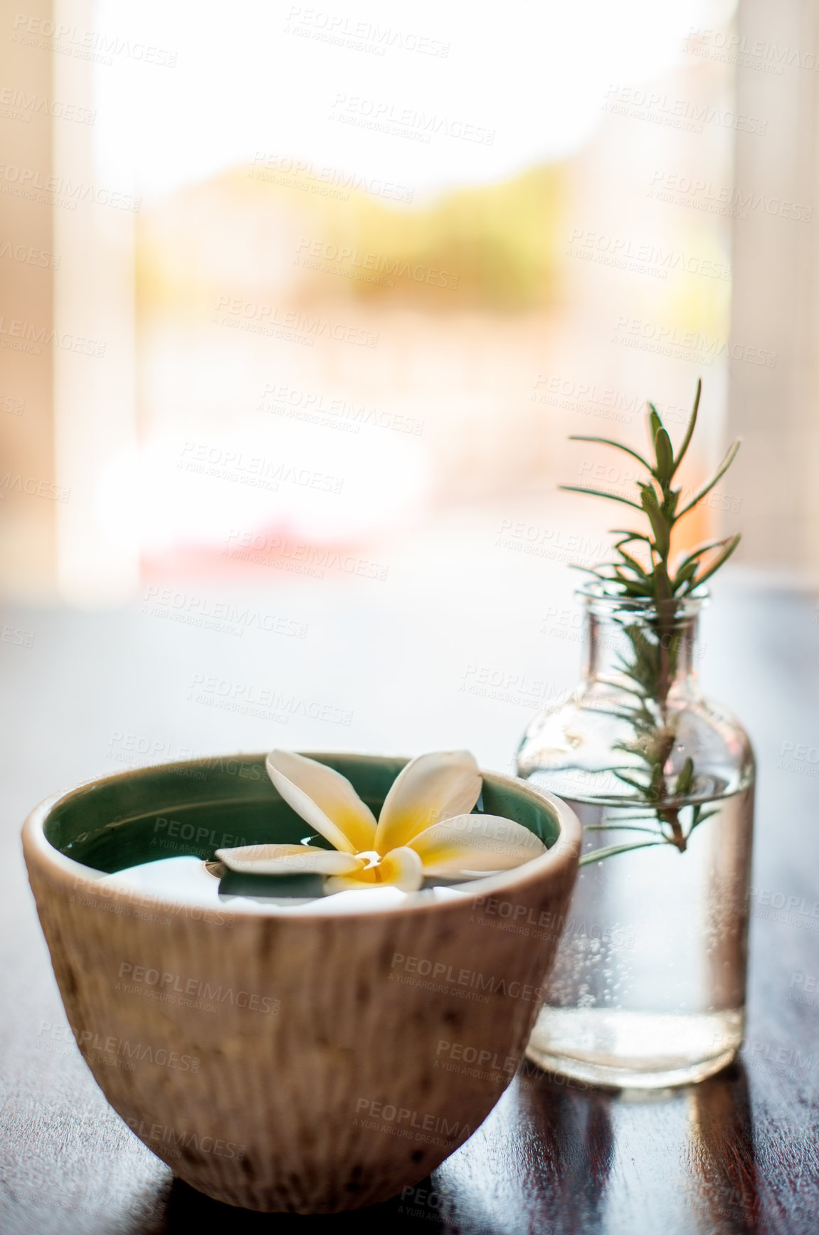 Buy stock photo Spa, bowl and water with flower for zen, tranquility or luxury salon for aroma, essence or therapy. Closeup, empty and natural plant with leaves for calming aesthetic, serene or relaxation at resort