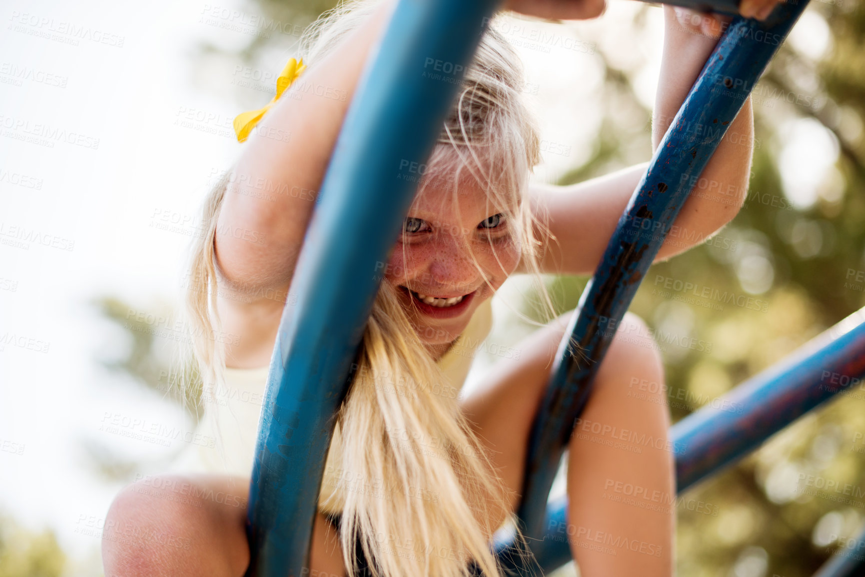 Buy stock photo Game, merry go round and smile with girl in forest for active play, child development or growth. Adventure, balance and carousel ride with happy kid having fun at playground in summer from below