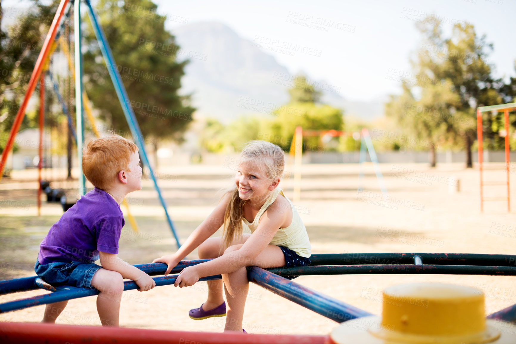 Buy stock photo Happy, kids and carousel at playground outdoor for fun game, energy and relax together. Children, brother and sister playing on park ride on holiday, family vacation and siblings spin on adventure