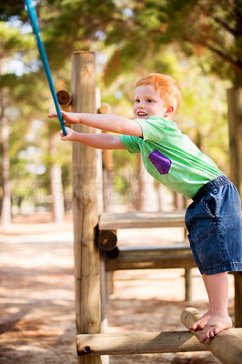 Buy stock photo Smile, kid and rope at playground park for fun game, swing and climbing with energy to exercise. Happy child, boy and playing outdoor on holiday, vacation and preschooler on adventure at jungle gym
