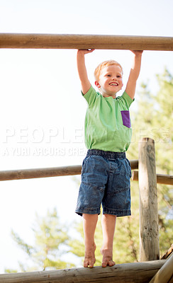 Buy stock photo Smile, child and outdoor playground with equipment, adventure and playful exercise. Happy, boy and motor growth with fun games, jungle gym balance and summer vacation for holiday childhood activity