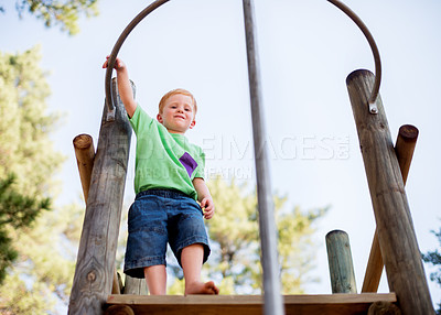 Buy stock photo Smile, playground and youth with boy in park for growth, adventure and climbing games. Low angle, happiness and kindergarten child playing outdoors for exercise, balance and  fun on summer holiday