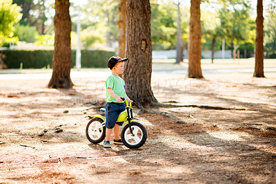 Buy stock photo Nature, child and boy with bicycle for thinking, learning and practice for physical development in park. Outdoor, kid and cycling with bike for coordination break, balance and childhood fun with ride