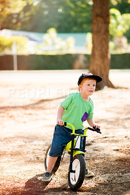 Buy stock photo Outdoor, kid and boy with bicycle for ride, learning and practice for physical development in park. Nature, child and cycling with bike for coordination, balance and childhood fun with activity