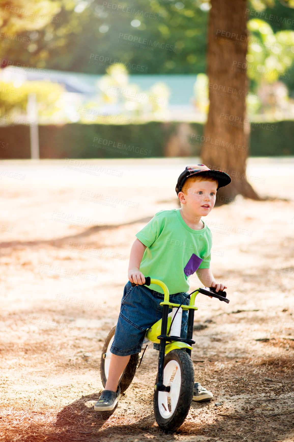 Buy stock photo Outdoor, kid and boy with bicycle for ride, learning and practice for physical development in park. Nature, child and cycling with bike for coordination, balance and childhood fun with activity