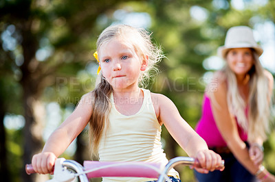 Buy stock photo Child, mom and teaching with bicycle in park with love, bonding and support in woods on holiday. Woman, girl and learning, cycling and bike on outdoor adventure, forest or vacation trail in nature