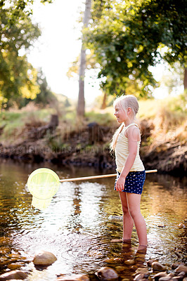 Buy stock photo Happy child, river and play with fishing net on vacation, holiday or adventure in countryside. Hobby, catch or girl in water with equipment for learning, explore or hiking to travel in nature outdoor
