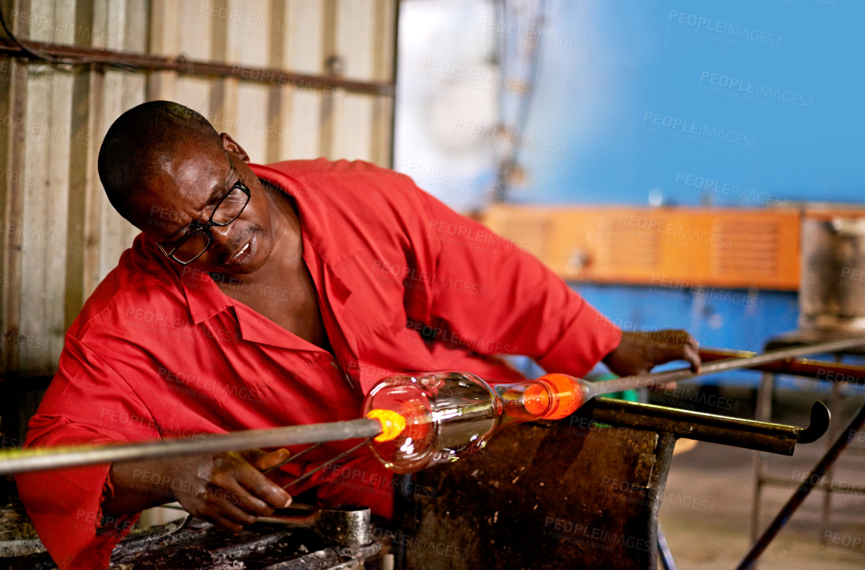 Buy stock photo Glass, blowing and black man in art workshop for small business with heat, tools or technique. Creative, handmade product or glassblower in factory for sustainable process, design or bottle sculpture