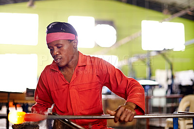 Buy stock photo Glass, blowing and black man in workshop for small business with heat, tools or craft technique. Creative, handmade product or glassblower in factory for sustainable art, design or bottle sculpture