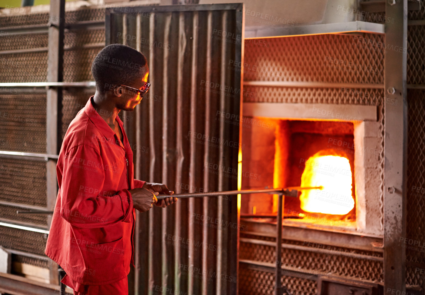 Buy stock photo Glassblowing, heat and man with tools, furnace and creative for manufacturing of glass and industry. Production, busy and person in uniform for craft, glassmakers and art for design of product