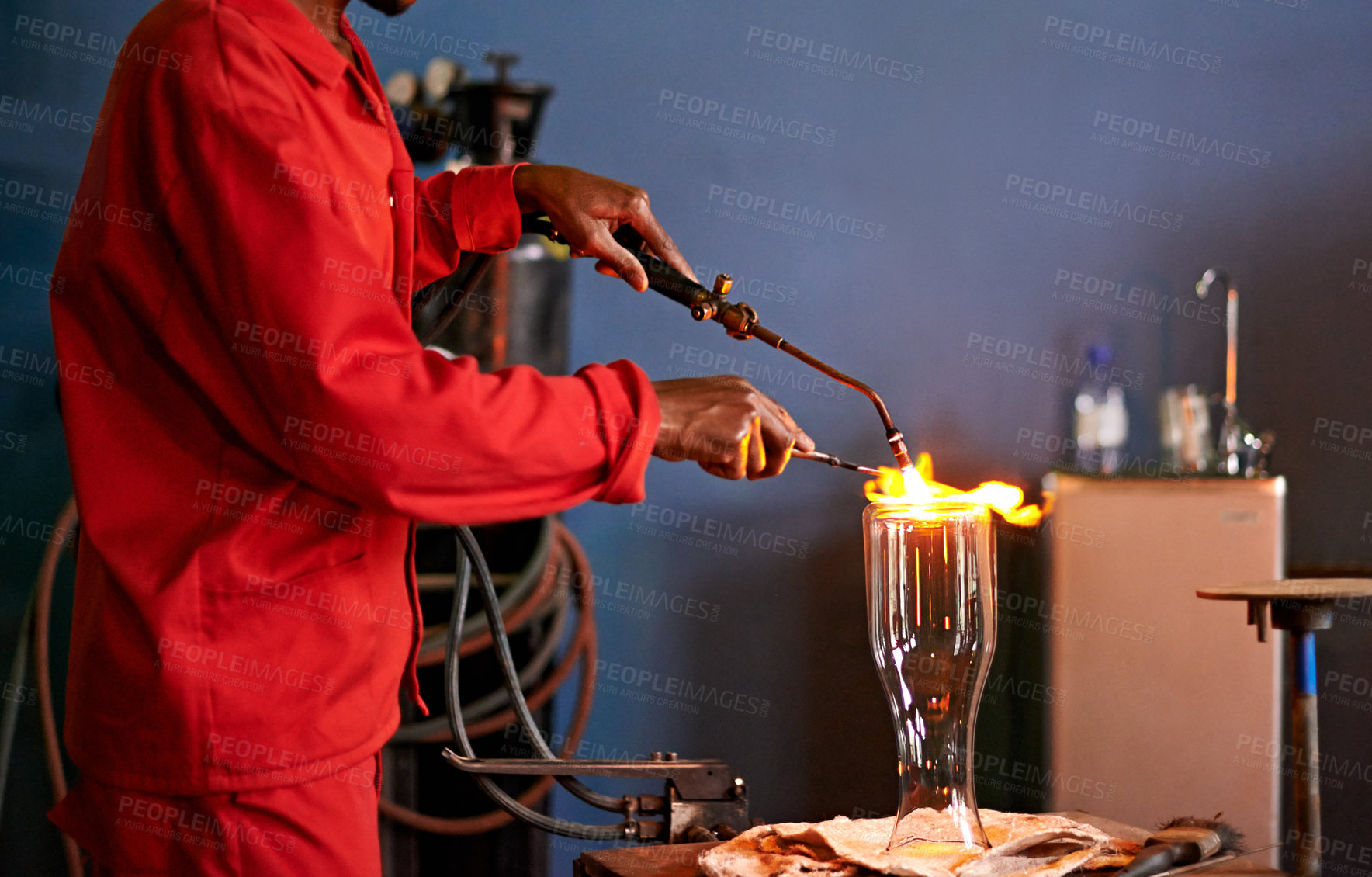 Buy stock photo Glassblowing, heat and man with blowtorch, shaping and creative for manufacturing of glass and industry. Production, busy and person in uniform for craft, glassmakers and art for design of product