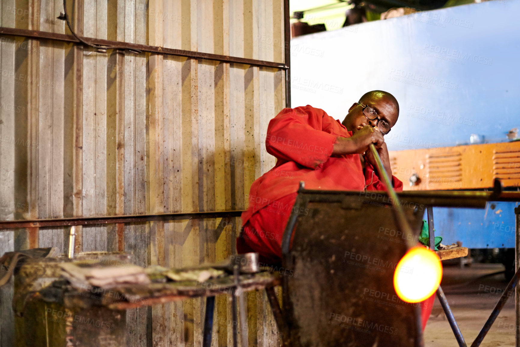 Buy stock photo Glassblower, tools and black man in factory, technique and warehouse for craftsmanship, equipment and industry. African person, metal and employee in workshop, manufacturing and production with skill