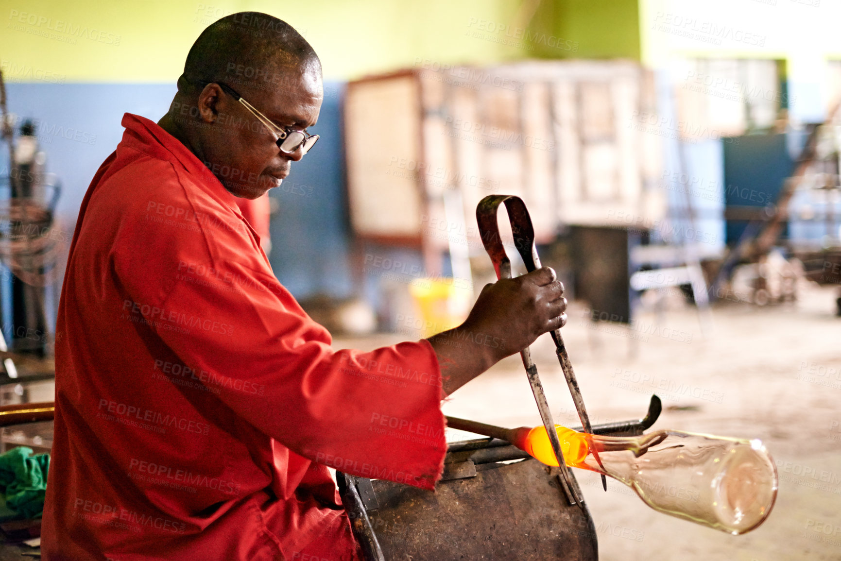 Buy stock photo Glass, blowing and black man in bottle workshop for small business, craft or handmade technique. Creative, product shape or glassblower in factory for sustainable process, design or sculpture art