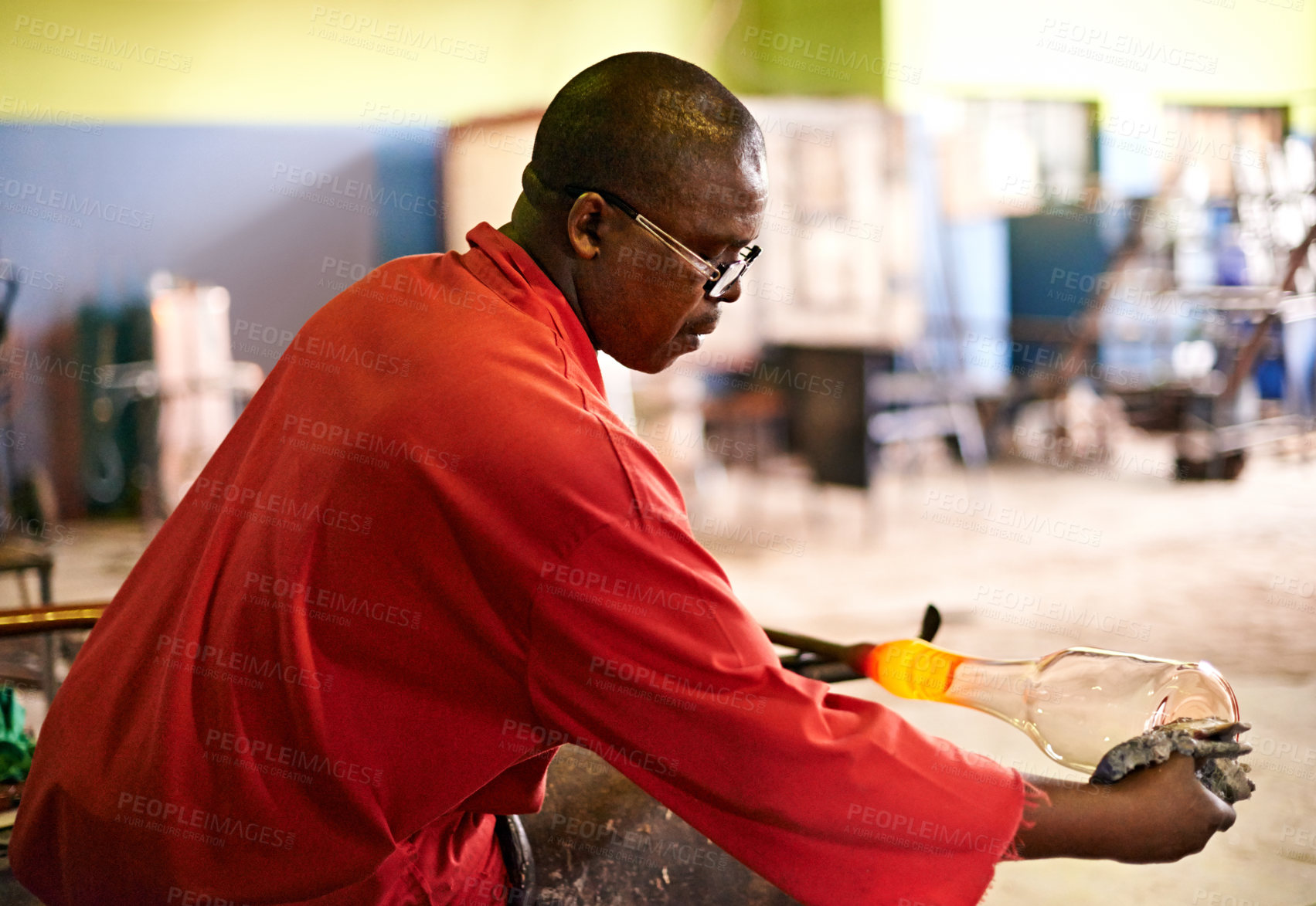 Buy stock photo Glassblower, tools and black man in factory, industry and warehouse with equipment, vase and fire. African person, technique or employee in workshop, manufacturing and craftsmanship with productivity
