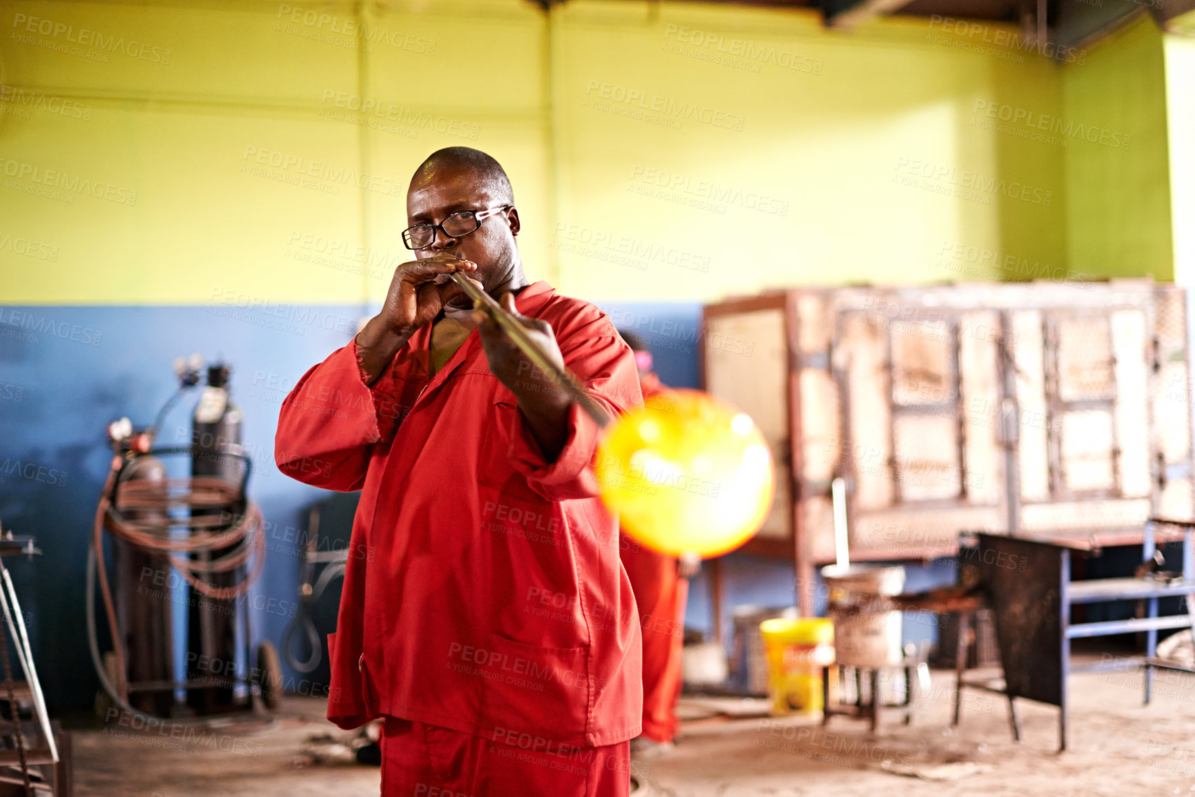 Buy stock photo Glassblowing, art and man with blowpipe, factory  and creative for manufacturing of glass and industry. Production, shaping and black person in uniform for craft, glassmaker and design for product