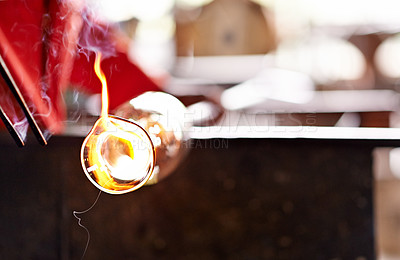 Buy stock photo Glass, glowing and heat with professional artisan closeup in workshop for manufacturing or production. Equipment, hot and smoke with glassblower person in forge or foundry for industrial process