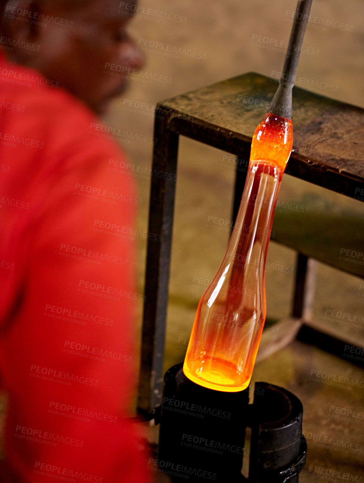 Buy stock photo Glassblower, tools and black man in warehouse, productivity and skills with craftsmanship, industry and process. African person, technique and employee in workshop, manufacturing and equipment