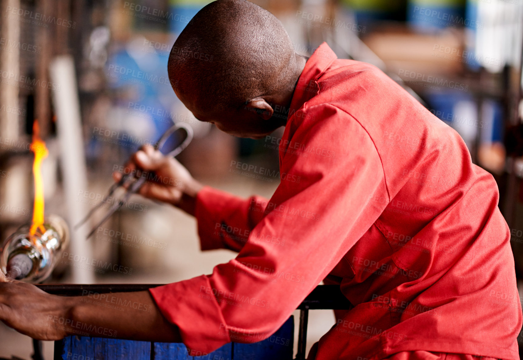 Buy stock photo Glassblower, tools and black man in factory, skills and warehouse for craftsmanship, equipment and fire. African person, technique and employee in workshop, manufacturing and industry with metal