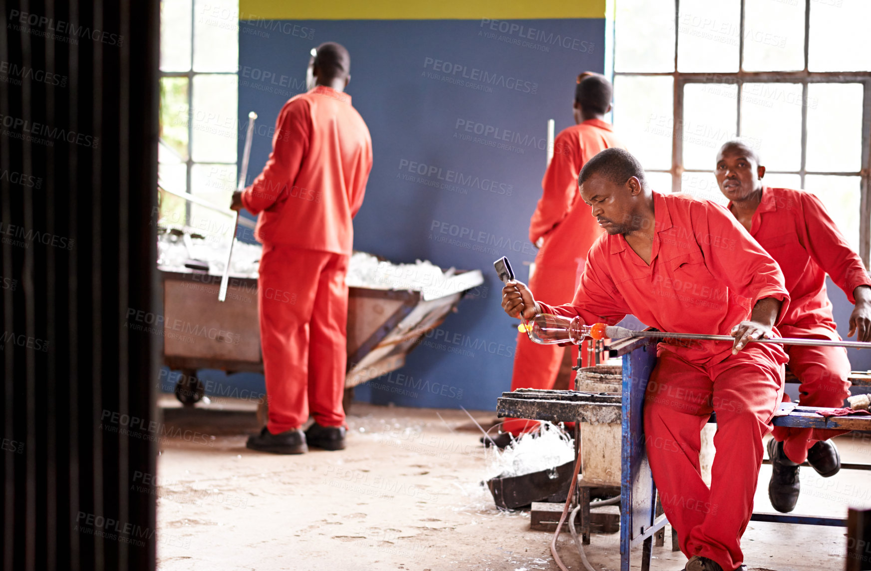 Buy stock photo Glassblower, heating and man in factory with production and equipment for professional craft. Labor, workshop and person shaping object with tools for metalwork, manufacturing and forge for molding