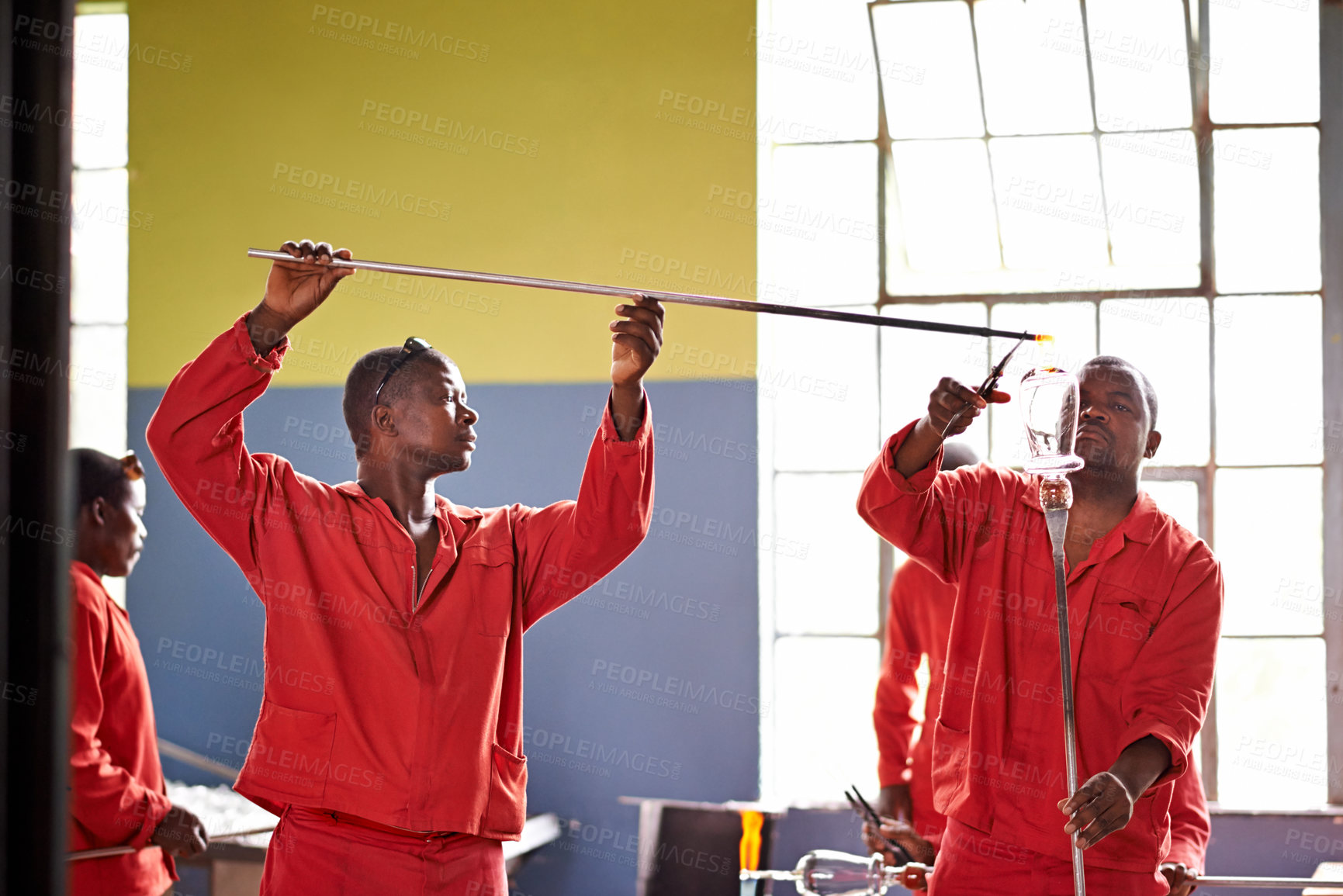 Buy stock photo Glassblowers, team and people in factory with heating equipment for professional craft production. Labor, workshop and shaping object with tools for metalwork, manufacturing and forge for teamwork