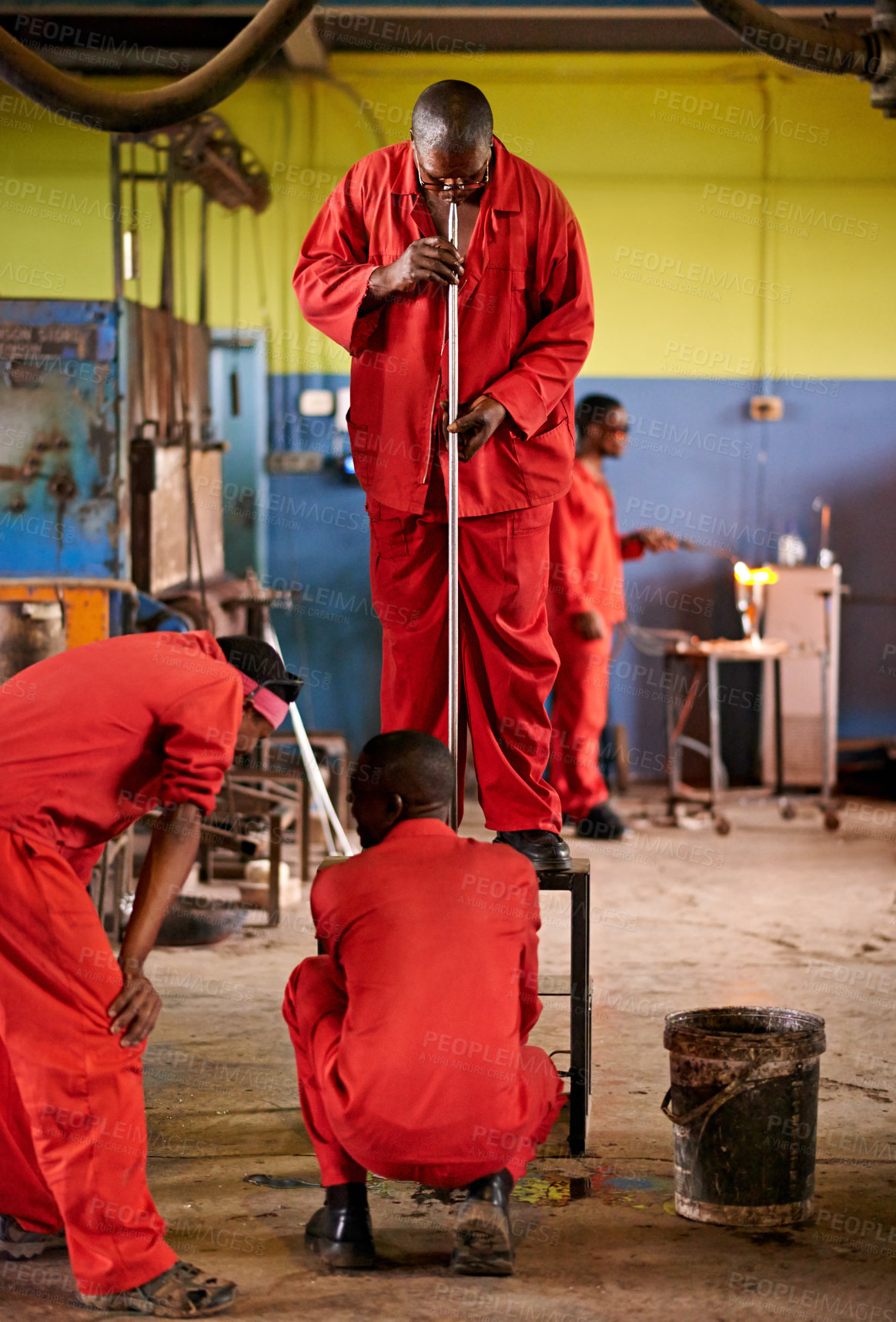 Buy stock photo Glass, blow and people in workshop for heating production and equipment for professional craft skills. Labor, factory and shaping object with tools for metalwork, manufacturing and forge for teamwork