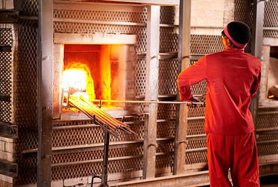 Buy stock photo Furnace, industry and man in workshop with glass for manufacturing windows or products for business. Craft , production and male glassblower with artisan sculpting by fire, heat or flame in factory.