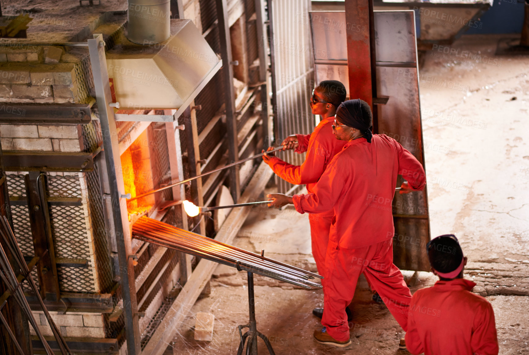 Buy stock photo Glassblowers, oven or people in factory manufacturing with heating equipment or professional craft. Top view, workshop and team of men shaping object with furnace tools for metalwork, labor or forge