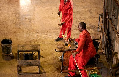 Buy stock photo Glassblowers, manufacturing or people in factory with heating equipment or professional craft. Top view, workshop and men shaping object material with tools for metalwork, labor or forge for teamwork