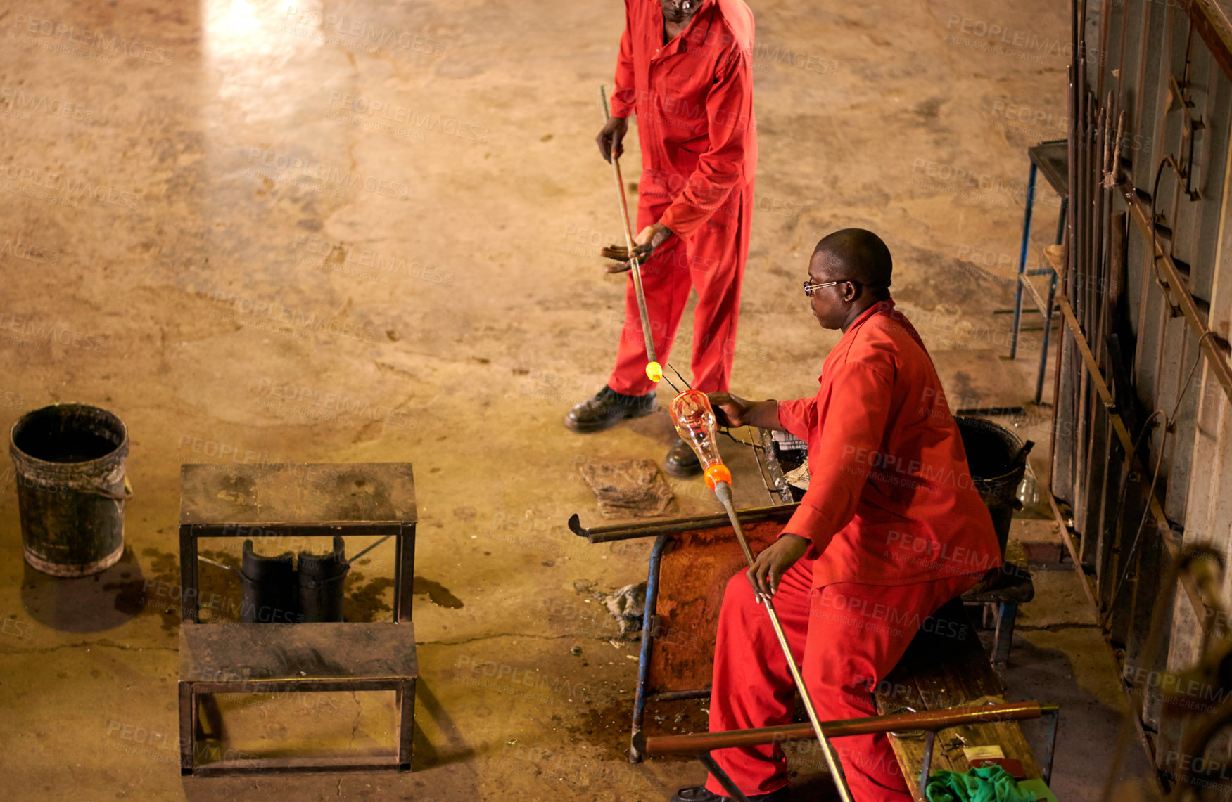 Buy stock photo Glassblowers, manufacturing or people in factory with heating equipment or professional craft. Top view, workshop and men shaping object material with tools for metalwork, labor or forge for teamwork