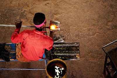 Buy stock photo Above, glassblower and black man with equipment, productivity and heat with technique, material and industry. Person, craftsmanship and employee in factory, manufacturing and tools with process