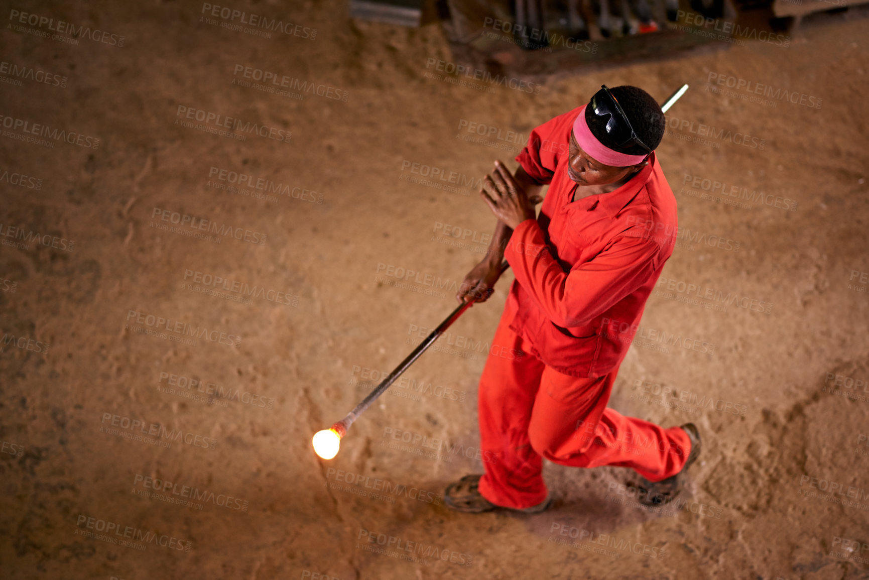 Buy stock photo Above, glassblower and black man in factory, tools and equipment with iron, skills and walking. African person, technique and employee with material, talent and process with manufacturing or industry