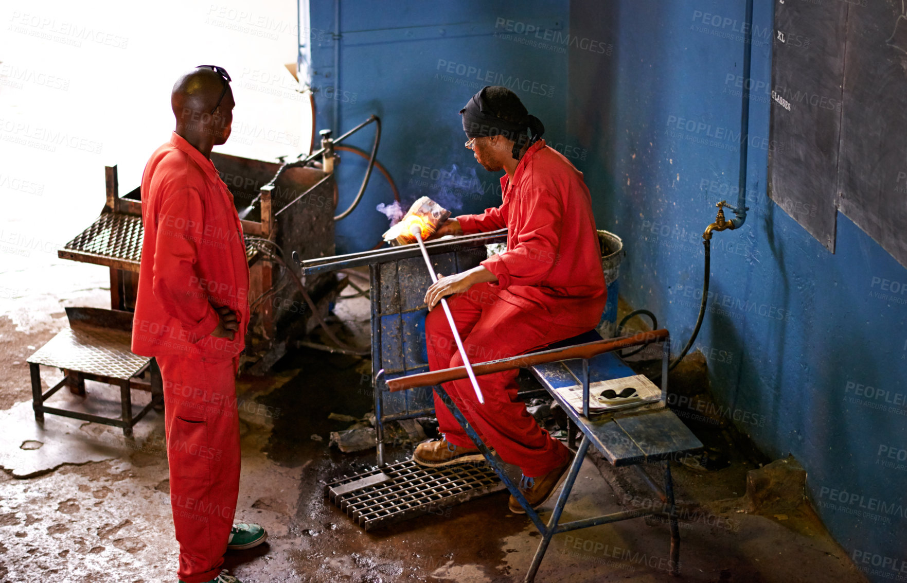 Buy stock photo Glassblowers, industry or people in workshop with heating equipment, professional craft or production. Labor, factory or team of men molding object with tools for metalwork, manufacturing and shape