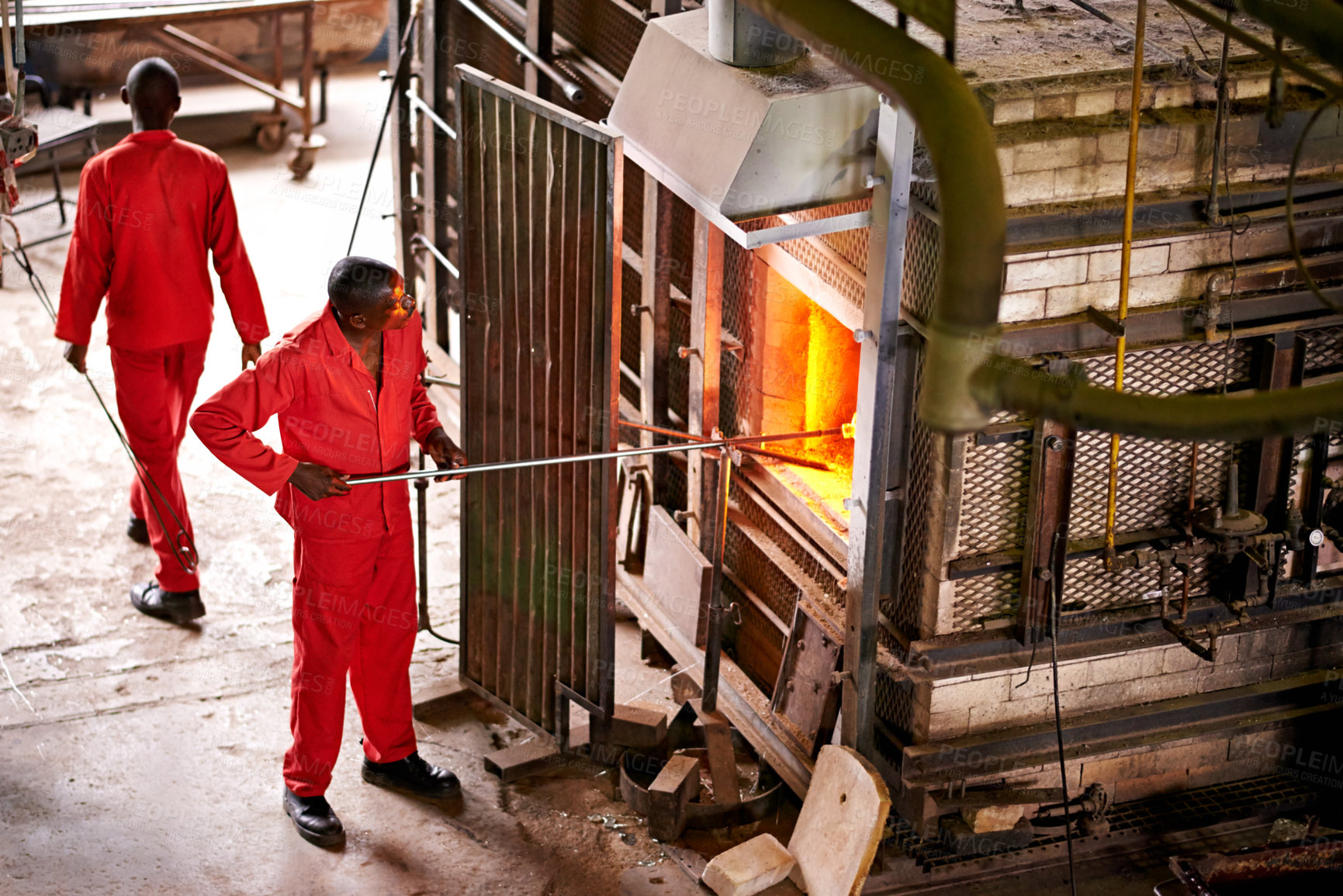 Buy stock photo People, glassblowers and men in factory, equipment and skills with talent, manufacturing and craftsmanship. Employees, technique and professional with tools, temperature and artistry with industry