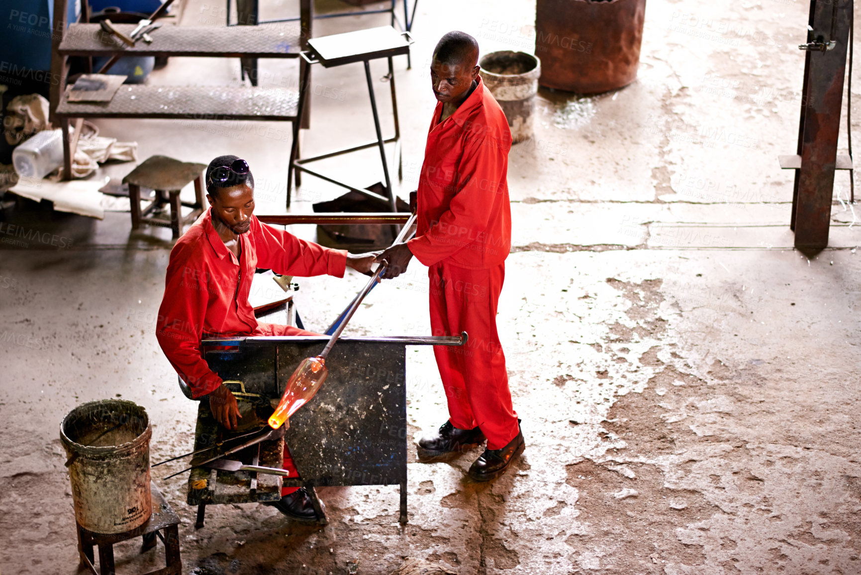 Buy stock photo Glassblowers, vase and people in workshop with heating equipment, professional craft and production. Labor, factory or top view of men molding object with tools for teamwork, manufacturing and shape