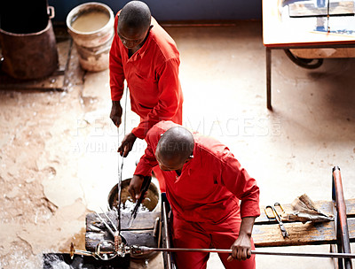 Buy stock photo Glassblowers, vase and people in workshop with equipment, professional craft and production. Teamwork, factory or top view of men molding object with tools for manual labor, manufacturing and shape