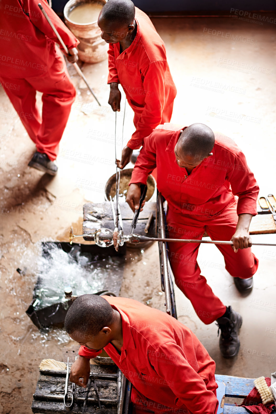 Buy stock photo Glassblowers, vase shape and people in workshop with equipment, professional craft and production. Teamwork, factory or top view of men molding object with tools for manual labor or manufacturing