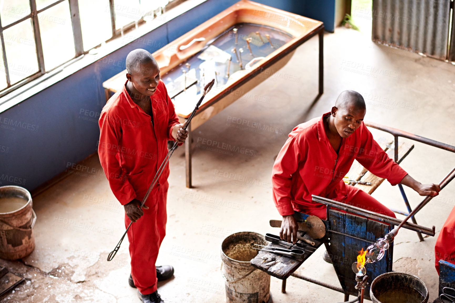 Buy stock photo Glassblowers, vase shape and man with fire for equipment, professional craft and production. Industrial, factory or top view of artisan molding object with tools for manual labor or manufacturing